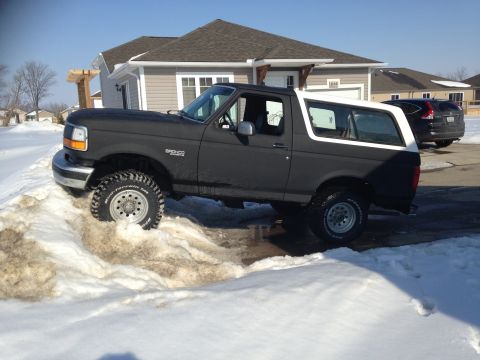 1992 Ford Bronco - This 1992 Ford Bronco is equipped with off-road tires and appears to be navigating a snowy driveway.