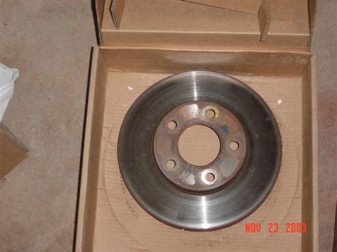 1999 Ford Mustang - A single brake rotor is shown in its cardboard packaging, with a visible date watermark.