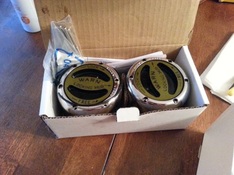 1981 Ford Bronco - Two new Warn locking hubs are shown in their original packaging, ready for installation.