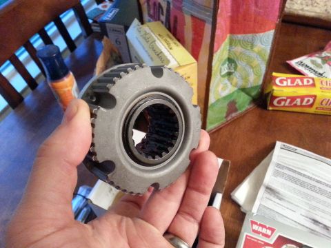 1981 Ford Bronco - Close-up of a vehicle's Warn Hub part, held in a hand.