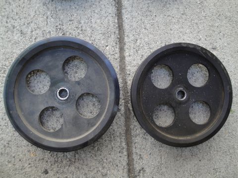 1995 Ford Taurus - Two drive pulleys are shown side-by-side on a concrete surface.