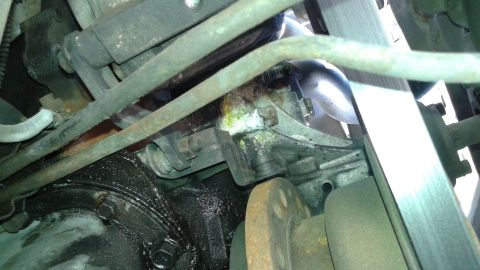 1988 Ford Bronco - Engine part showing signs of an oil leak, with various hoses and mechanical components visible.