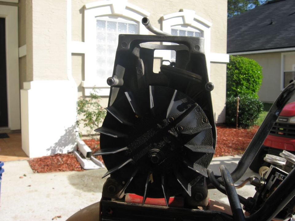 Black fan assembly for an air compressor, with a metal tube extending upwards