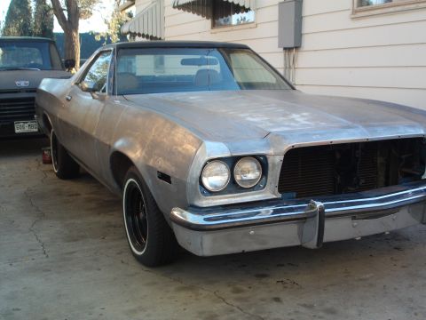 1973 Ford Ranchero - This 1973 Ford Ranchero is shown in a 3q-front view, appearing to be in a state of restoration with its unpainted body and black vinyl roof.