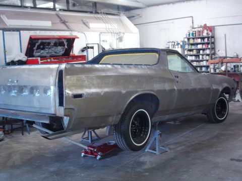 1973 Ford Ranchero - This vehicle is undergoing bodywork and is supported by jack stands in a garage setting.