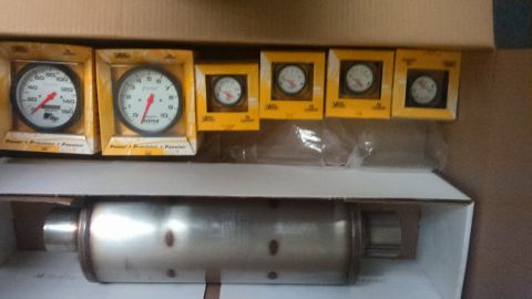Gauges and exhaust muffler in boxes