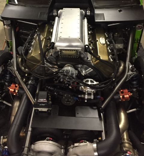 1965 Ford Fairlane - A highly modified engine bay twin turbochargers and a custom intake system is viewed from above.