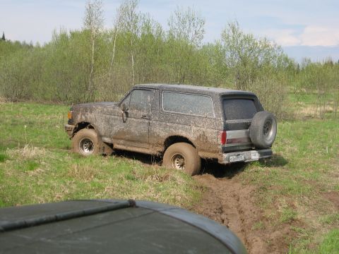 1987 Ford Bronco - This 1987 Ford Bronco is stuck in the mud, with its tires deep in the mire.
