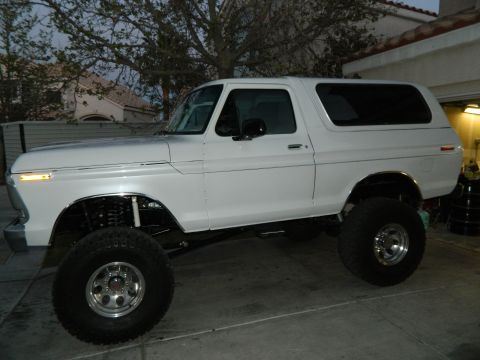 1979 Ford Bronco - This lifted 1978 Ford Bronco is parked in a driveway, showing its modified suspension and off-road tires.