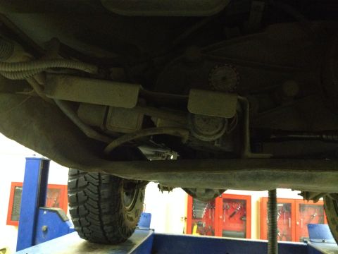 2005 Jeep Wrangler - Underside view of a vehicle on a lift, revealing suspension and exhaust components.