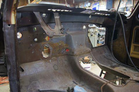 1979 Ford Bronco - Interior of a 1979 Ford Bronco undergoing restoration, with significant rust visible on the dashboard and floor.