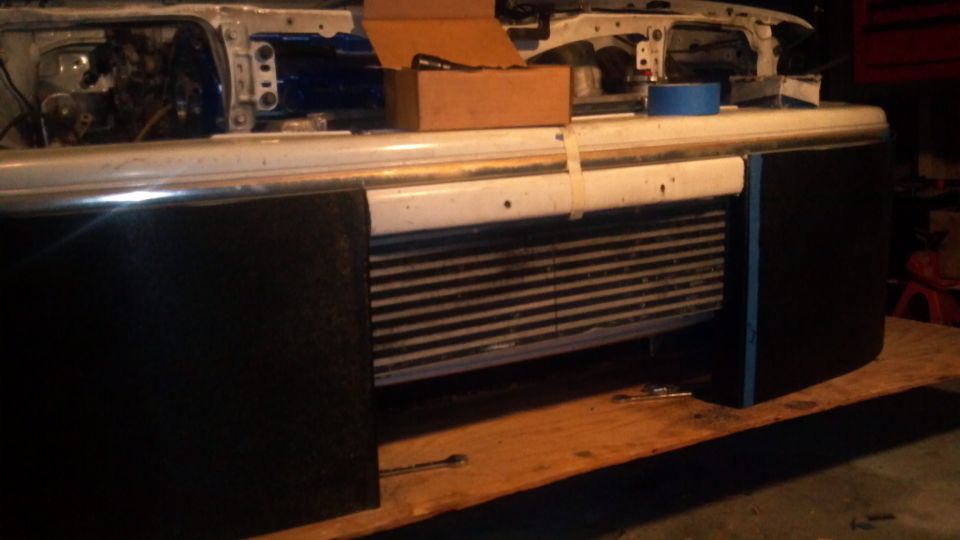 Car front end with intercooler installed, hood removed, showing engine bay components