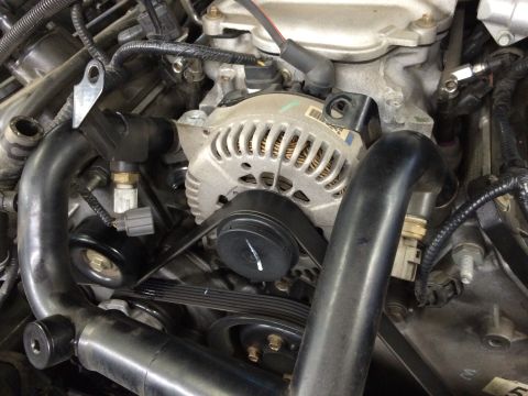 2003 Mercury Marauder - Close-up view of engine components, including the alternator and drive belts.