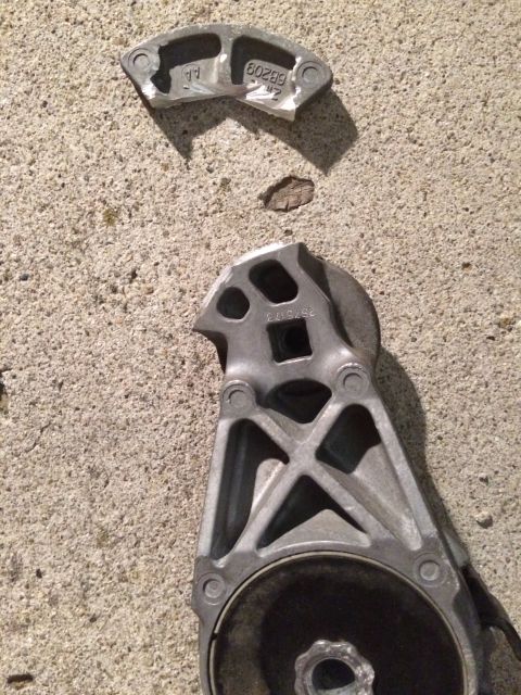 2003 Mercury Marauder - A broken engine mount part lies on a concrete surface, showing visible part numbers.