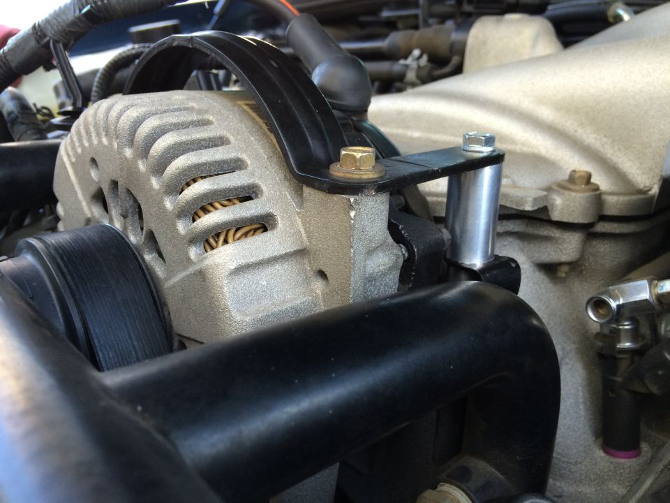 Close-up of car alternator and intake manifold