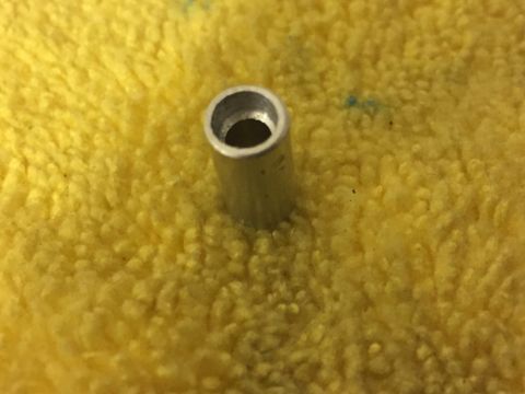 2014 Dodge 1500 - A close-up view of a metal tube resting on a textured yellow surface, with a Supermotors logo visible in the lower right corner.
