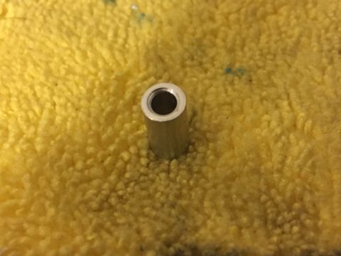 2014 Dodge 1500 - A metal spacer is shown on a yellow textured surface.