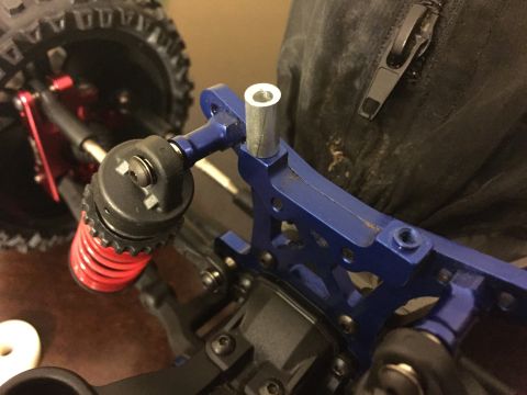 2014 Dodge 1500 - This is a close-up view of a blue aluminum suspension part from an RC car, a red shock absorber.