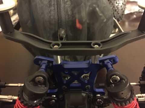 2014 Dodge 1500 - Close-up view of a remote control car's steering mechanism, blue anodized aluminum parts and black handlebars.