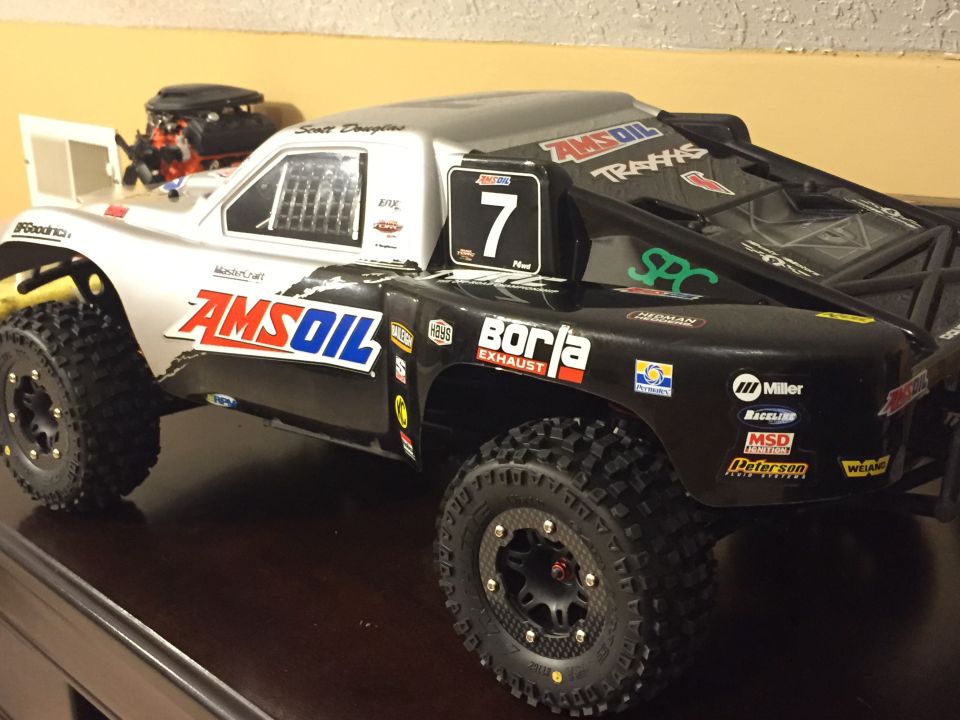 Remote control short course truck with AMSOIL and Traxxas decals, number 7 on door