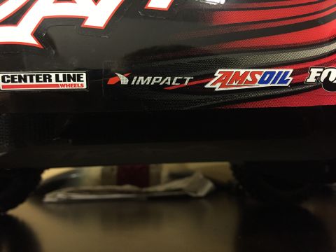 2014 Dodge 1500 - Close-up of a truck's side decal showing sponsor logos like Center Line Wheels, Impact, Amsoil, and Fox.