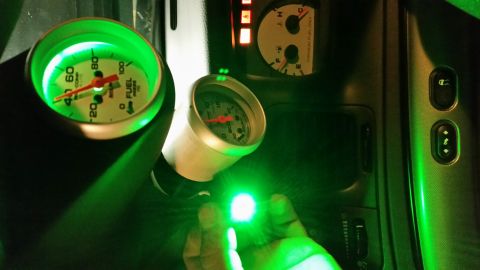 2004 Mercury Grand Marquis - Aftermarket gauges with green backlighting are installed in the vehicle's dashboard.