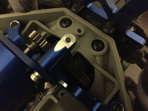 2014 Dodge 1500 - The internal workings of a remote-controlled car's transmission system are visible, metal gears and blue components.