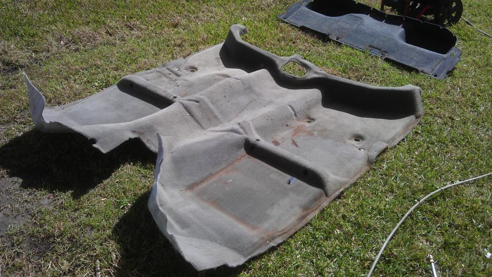 Gray car interior carpet removed from vehicle