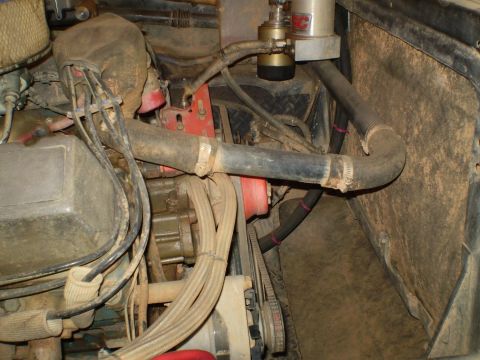 1978 Ford Bronco - Close-up view of the engine bay, showing various components like hoses, belts, and a fuel filter.
