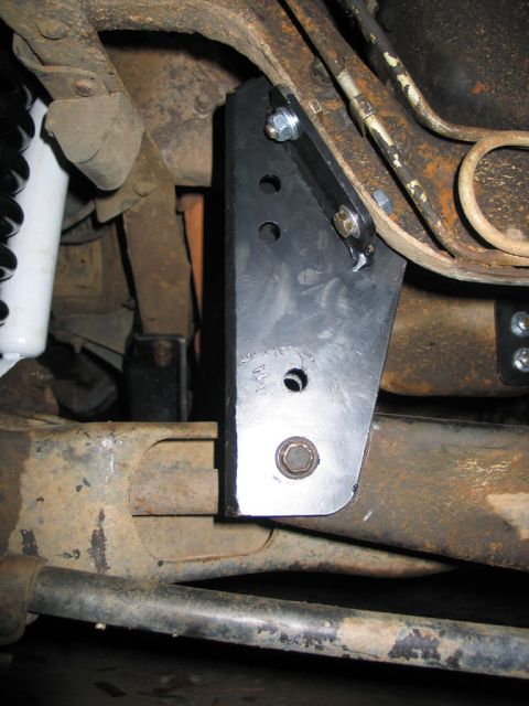 1995 Ford Bronco - A custom bracket is installed on the vehicle's suspension system, showing the mounting hardware and surrounding components.