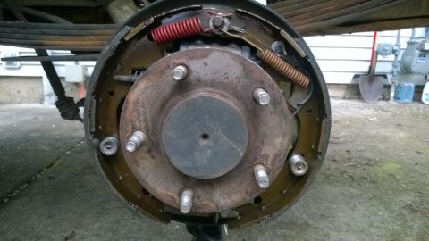 1994 Ford Bronco - Close-up view of a vehicle's rear drum brake assembly, showing the brake shoes and springs.