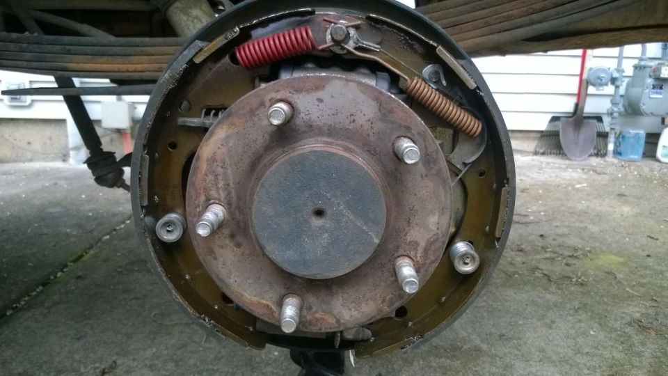 Rear drum brake assembly with red and brown springs