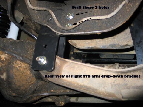 1995 Ford Bronco - Close-up view of a suspension bracket installation, with instructions for drilling holes.