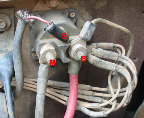 1990 Ford Bronco - Close-up of a vehicle's starter solenoid and its wiring connections.