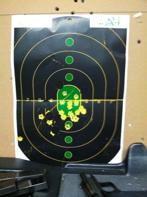 1976 Dodge Power Ram - A target with numerous bullet impacts, some clustered in the center green zone.
