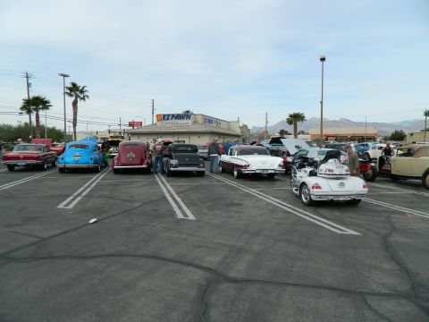 1979 Ford Bronco - A collection of vintage automobiles are gathered in a parking lot under a cloudy sky.