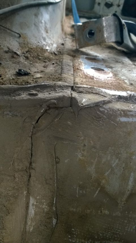 1994 Ford Bronco - Close-up of rusted metal frame showing significant cracks and wear.