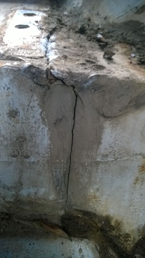 1994 Ford Bronco - A close-up view of a damaged concrete structure with significant cracking.