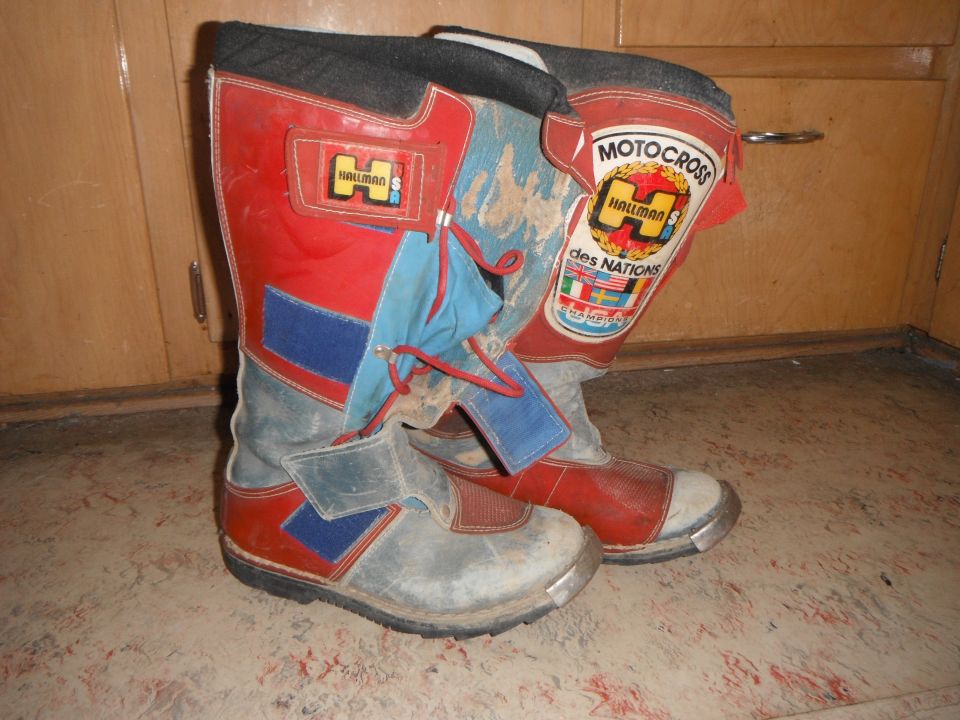 Pair of red, blue, and gray Hallman motocross boots with "Motocross des Nations" patch