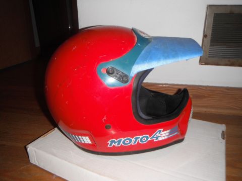 1966 Ford Bronco - Red motorcycle helmet with blue visor and "MOTO 4" graphics on the side.