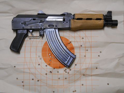 1994 Ford Bronco - An AK-47 style rifle rests on a target, showing evidence of recent use.