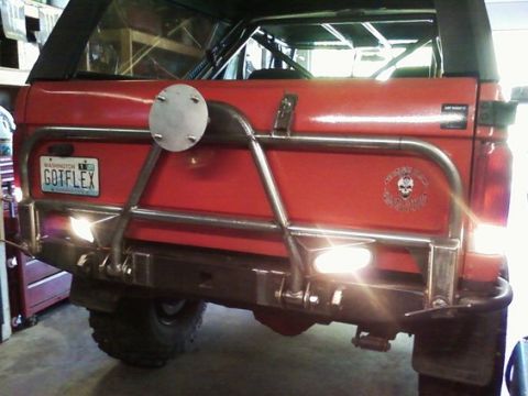 1988 Ford Bronco - This red SUV's rear features a custom bumper and spare tire mount, with a Washington license plate reading GOTFLEX.