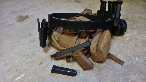 1996 Ford Bronco - Tactical belt setup with a pistol, spare magazine, and magazine pouches.