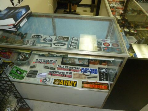 1992 Ford Mustang - A retail display case is filled with various stickers, including military branches and political statements.