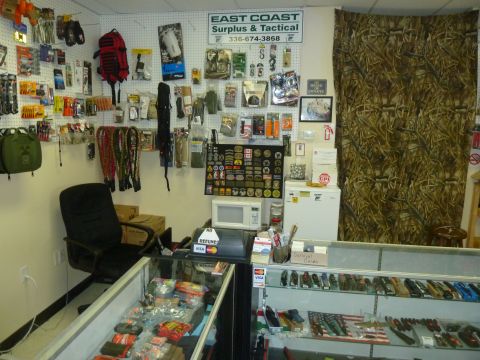 1992 Ford Mustang - Interior view of East Coast Surplus & Tactical store, displaying various merchandise and store signage.