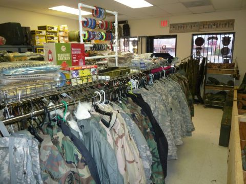 1992 Ford Mustang - A view inside a store displaying various camouflage jackets, paracord bracelets, and other outdoor equipment.