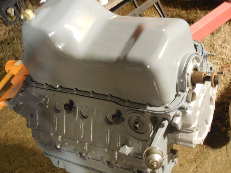 Gray repainted engine block on a stand outdoors