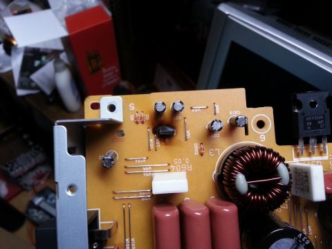 1994 Ford Bronco - This electronic circuit board features several components, including a prominent inductor and capacitors.