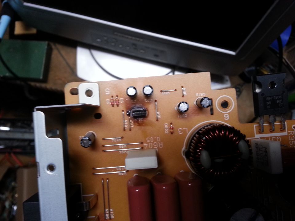 Circuit board with burnt component, capacitors, and inductor
