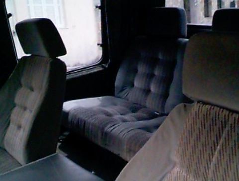 1970 Ford F-100 - The interior of a vehicle shows the rear bench seat and a portion of the front passenger seat.